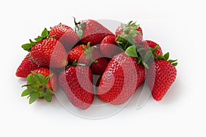 Group of fresh, ripe red strawberries with green leaves