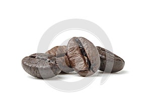 Group of fresh roasted dark brown arabica coffee beans isolated on a white background with clipping path