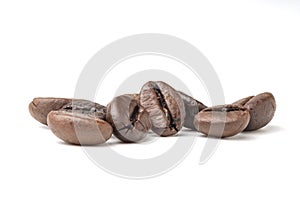 Group of fresh roasted dark brown arabica coffee beans isolated on a white background with clipping path