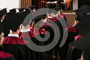 Group of fresh university graduates with robes and caps in ceremony