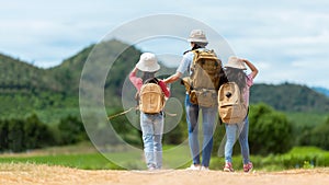 Group friend children travel nature summer trips.  Family Asia people tourism walking on road happy and fun explore adventure outd