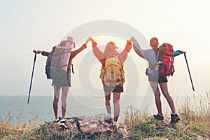 Group friend team asian young women of hikers walking adventure with backpack on a mountain at sunset. Traveler life going trip ca