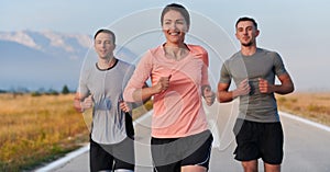 A group of friends, athletes, and joggers embrace the early morning hours as they run through the misty dawn, energized