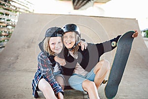 Group of friends athletes skateboarders posing together in a skate park. Caucasian children having fun together on sports urban