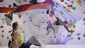 Group of friends bouldering at a climbing wall