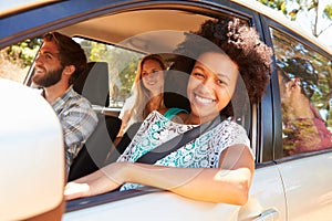 Group Of Friends In Car On Road Trip Together photo