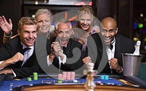 Group of friends celebrating win at roulette table