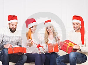 Group of friends in Christmas hats celebrating