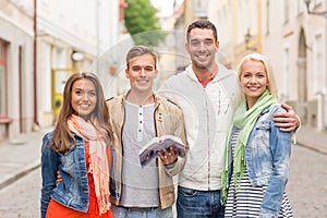 Group of friends with city guide exploring town