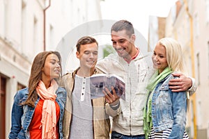 Group of friends with city guide exploring town