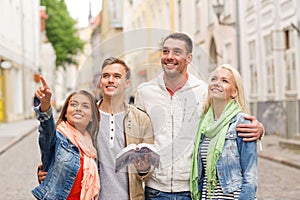 Group of friends with city guide exploring town