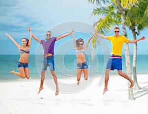 Group of friends or couples jumping on the beach