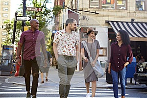 Group Of Friends Crossing Urban Street In New York City