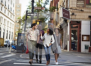 Group Of Friends Crossing Urban Street In New York City