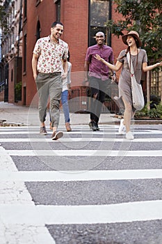 Group Of Friends Crossing Urban Street In New York City