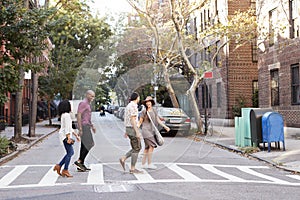 Group Of Friends Crossing Urban Street In New York City