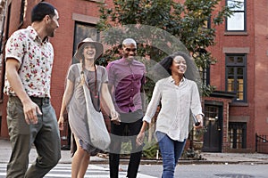 Group Of Friends Crossing Urban Street In New York City