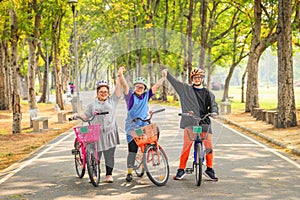 Group of friends with down syndrome or autism riding bicycle together