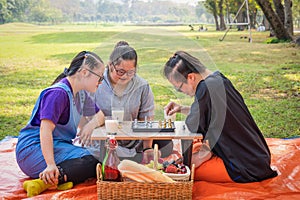 Group of friends with down syndrome playng chess board together