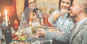 Group of friends drinking appetizer in vintage american bar - Young people eating finger food and drinking tropical fruits