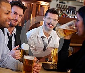 Group of friends drinking beer at pub