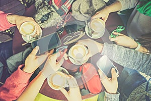 Group of friends drinking cappuccino at coffee bar restaurant