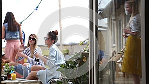 Group of friends drinking and having fun at rooftop party