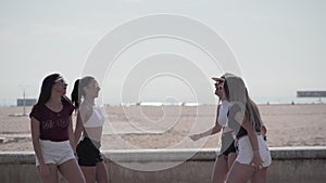 Group of friends embracing and showing their love by the beach