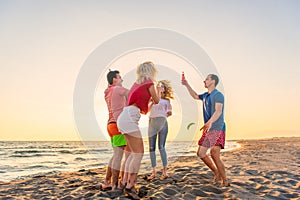 Group of friends enjoy on the beach