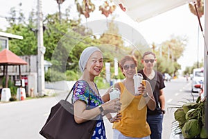 Group of friends enjoy drik at street food festival outdoor.