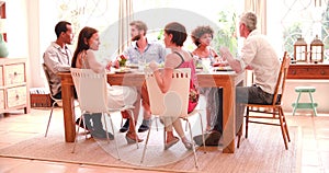 Group Of Friends Enjoying Dinner Party At Home Together