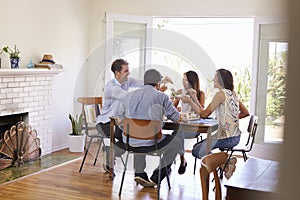 Group Of Friends Enjoying Dinner Party At Home Together