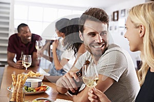 Group Of Friends Enjoying Dinner Party At Home Together