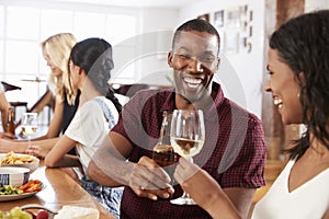 Group Of Friends Enjoying Dinner Party At Home Together