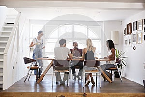 Group Of Friends Enjoying Dinner Party At Home Together