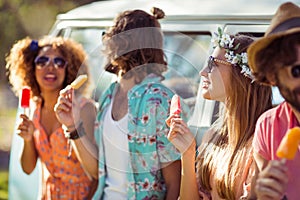 Group of friends enjoying and eating ice lolly