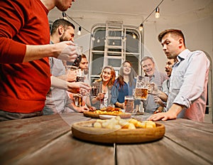 Group of friends enjoying evening drinks with beer