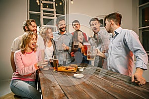 Group of friends enjoying evening drinks with beer