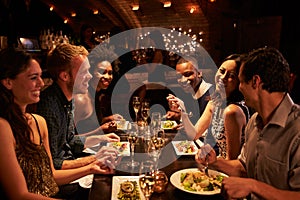 Group Of Friends Enjoying Meal In Restaurant