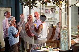 Group Of Friends Enjoying Outdoor Evening Drinks Party