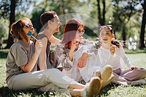 Group of friends enjoying sunny day in park with lollipops and laughter