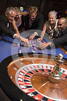 Group of friends gambling in casino