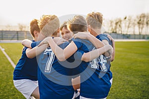 Group of friends happy kids in school sports team. Boys gathering and having fun on sports field. Cheerful children boys players