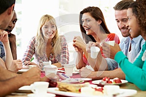 Group Of Friends Having Cheese And Coffee At Dinner Party