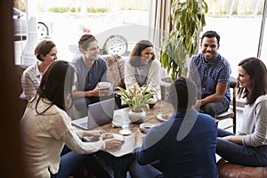 Group of friends having coffee together at a coffee shop