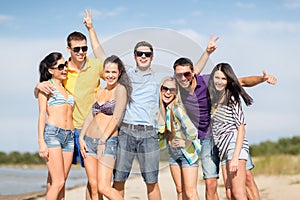 Group of friends having fun on the beach