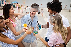 Group of friends having fun on the beach. Summer holidays, vacation and people concept.