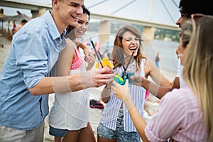 Group of friends having fun on the beach. Summer holidays, vacation and people concept.