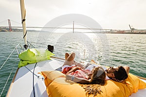 Group of friends having fun in boat in river
