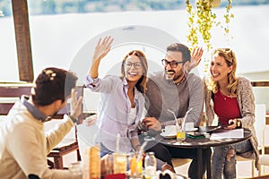 Group of friends having fun in cafe